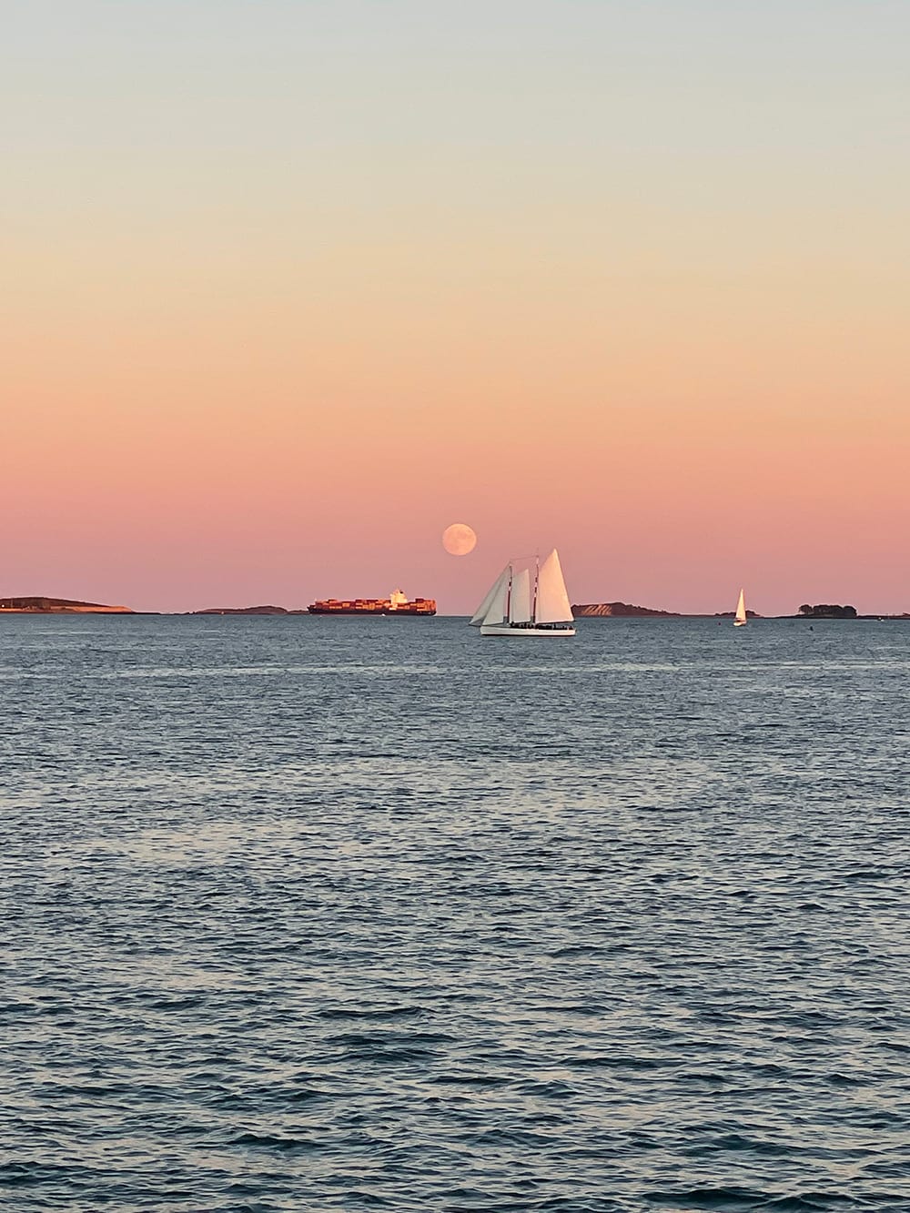 Boston skyline at sunset from the harbor